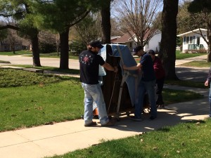 Four Luther Student Wrestlers have no problem wrangling this piano through the streets of Decorah.